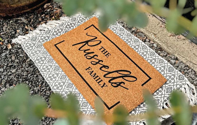 The Russells Family doormat on a patterned layering rug