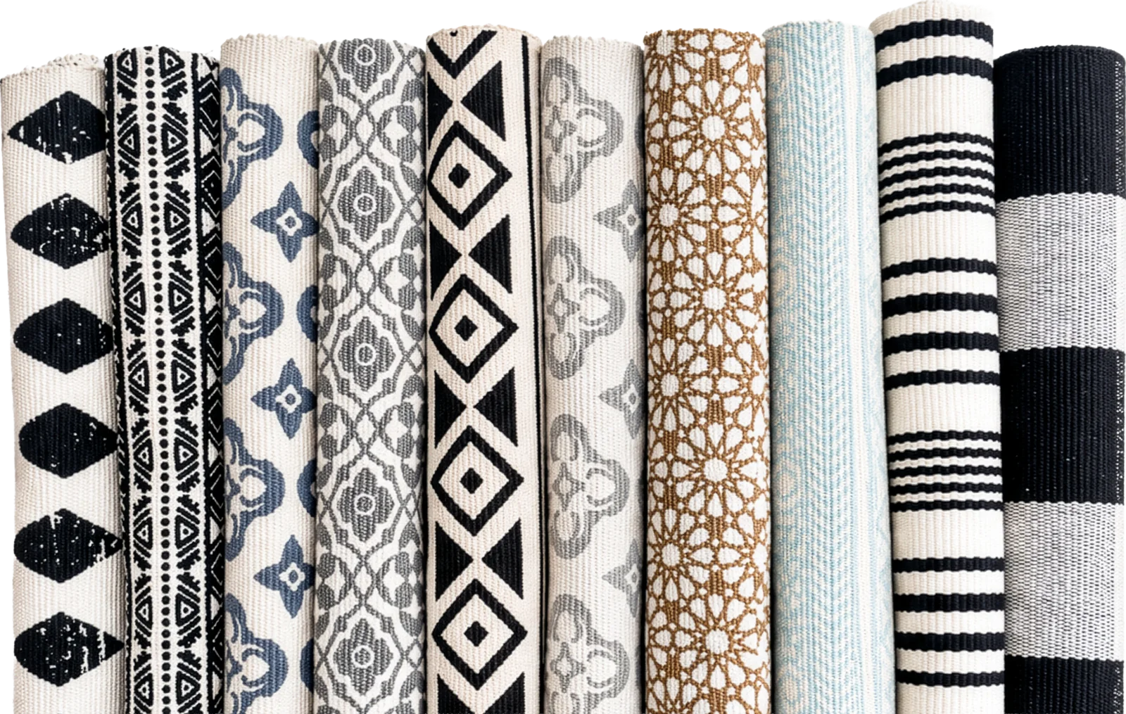 All ten layering rugs rolled side by side